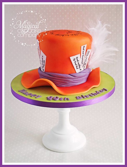 Mad Hatter style birthday cake with personalised messages on the 'tickets' and an inscription on to by The Magical Cupcake Company