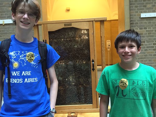 Josh Landweber and Jonah Docter-Loeb standing in front of their favorite exhibit for the day, the Agriculture Research Service's Bee Research Lab demo