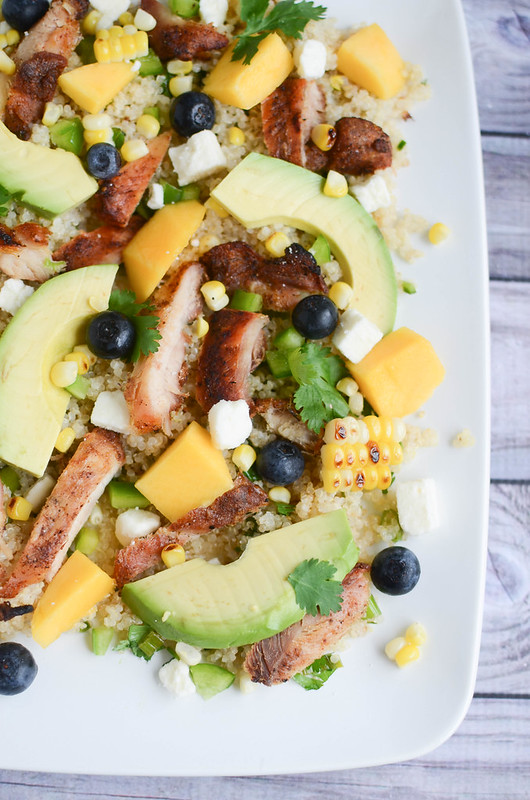 Blackened Chicken and Quinoa Salad - quinoa topped with blackened chicken, avocado, mango, bell peppers, corn, blueberries, feta, and a lime vinaigrette!