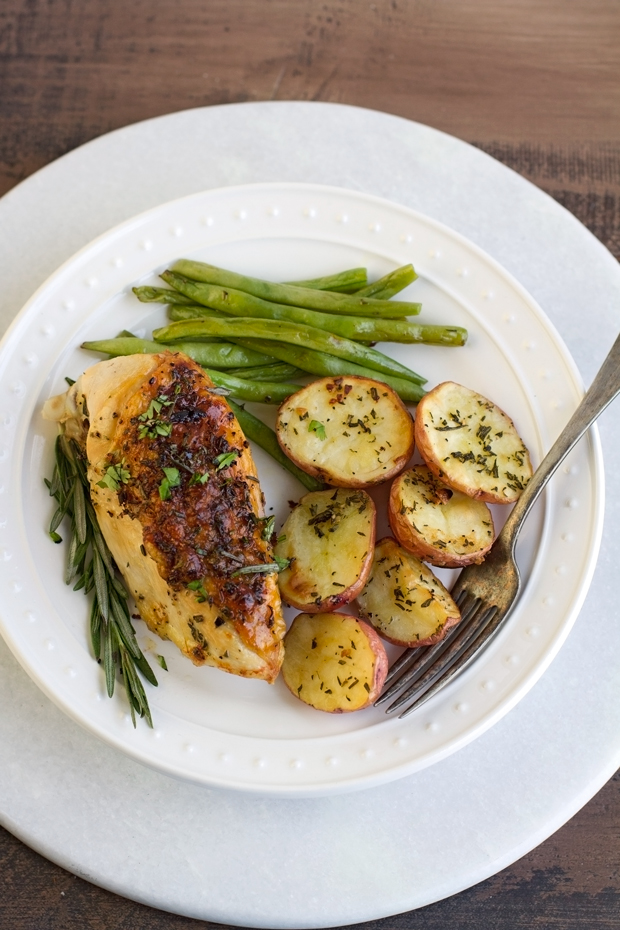 One Sheet Pan Rosemary Chicken + Potatoes & Green Beans - ALL cooked on one sheet pan and ready in under an hour! #roastedchicken #rosemarychicken #roastedpotatoes #onepandinner | Littlespicejar.com