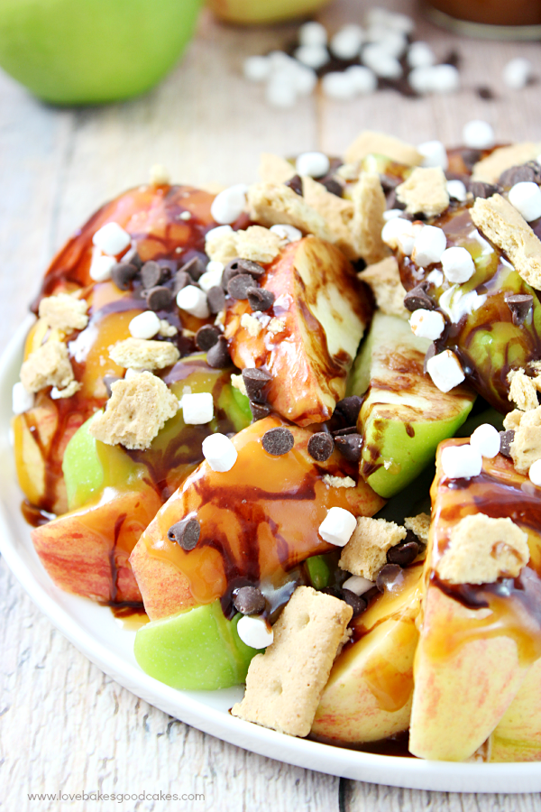 S'mores Salted Caramel Apple Nachos on a plate close up with marshmallows.