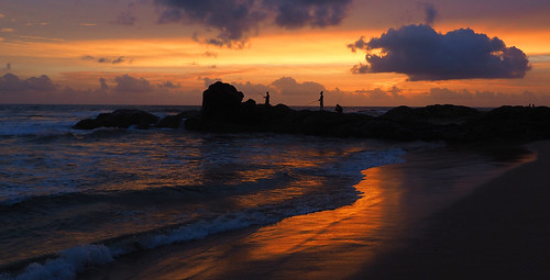 ocean travel sunset people sun seascape colour reflection beach silhouette clouds landscape fishing fisherman rocks waves sundown traditional srilanka bentota