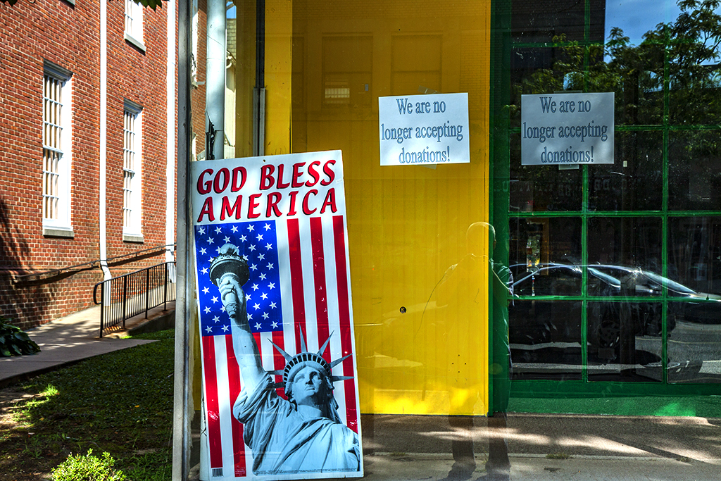 GOD BLESS AMERICA poster in window of out of business store--Woodbury