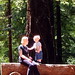 nick standing on a redwood bench beside his mom   dscf8669