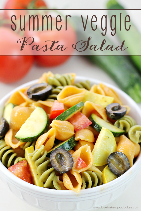 Summer Veggie Pasta Salad in a white bowl with fresh vegetables.