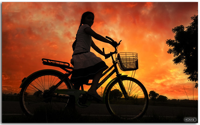 Girl at dusk riding homewards!