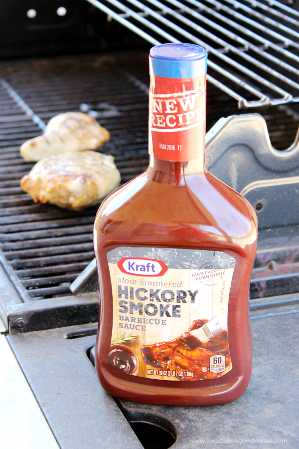 A bottle of hickory smoke bbq sauce by the grill.