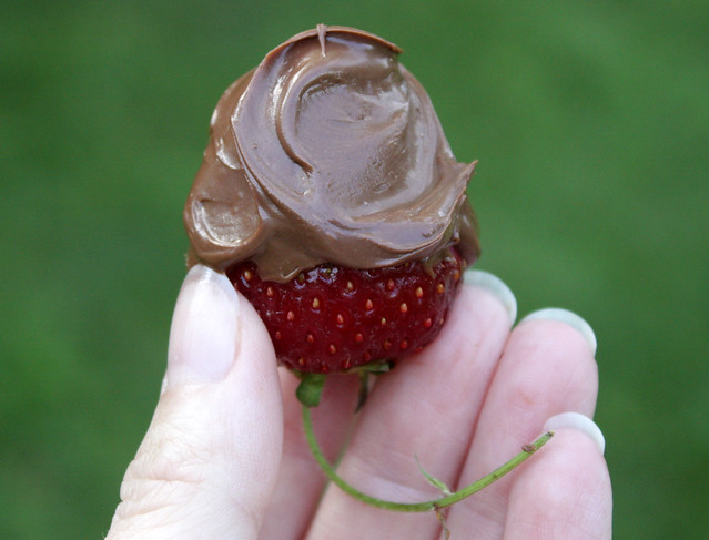 one strawberry covered with Nutella