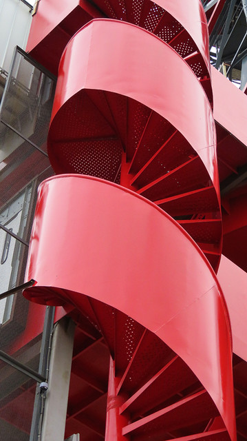 A bright red spiral staircase in NDSM, an industrial area across the river from Amsterdam