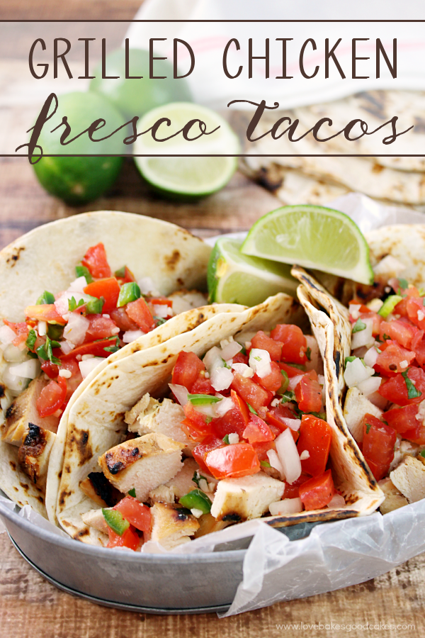 Grilled Chicken Fresco Tacos in a metal dish with fresh limes.