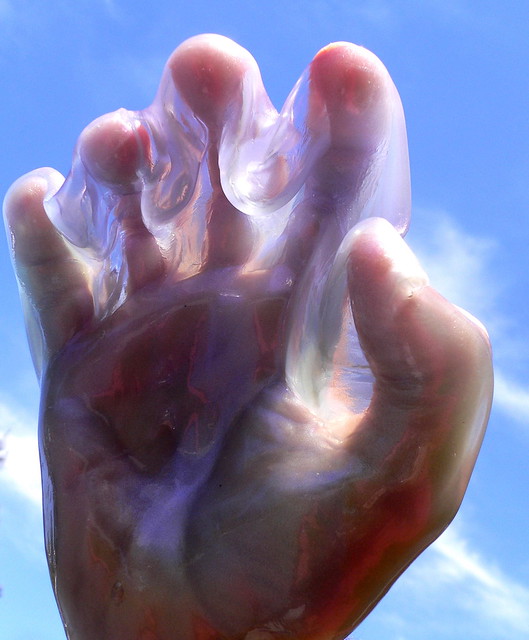 A hand covered in a clear slime