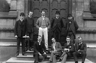 9 men in front of ornate door, Trinity College, Dublin