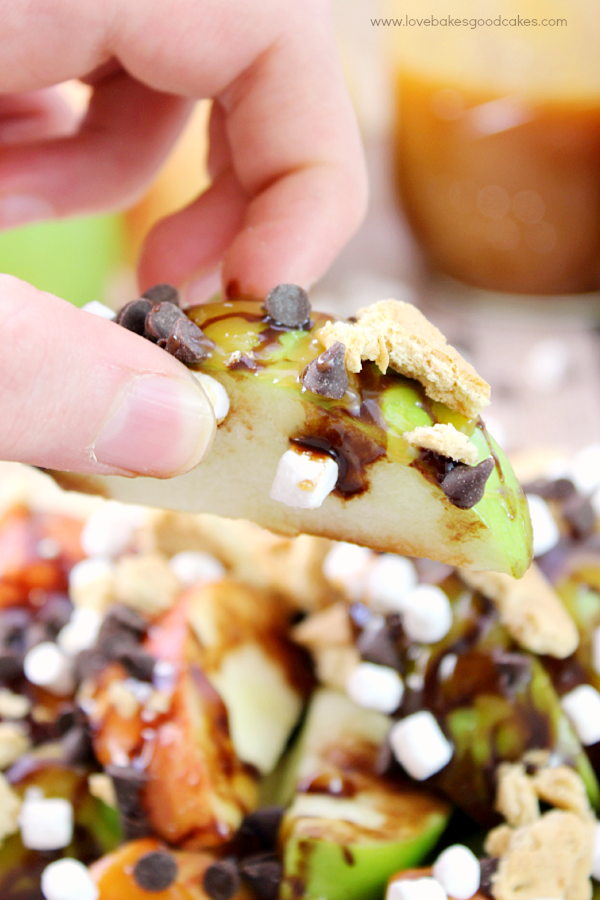 S'mores Salted Caramel Apple Nachos on a plate close up in someone's hand.