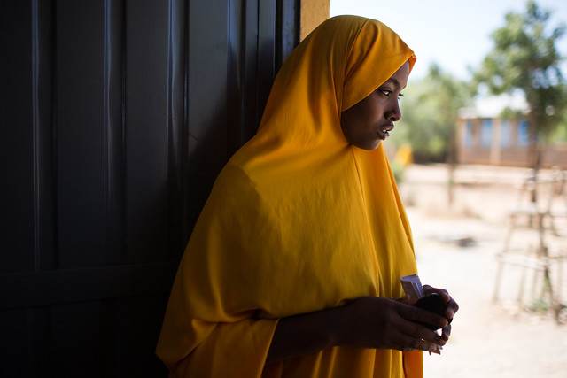 A member of a high school Girls Club waits by the door for their meeting to start in Jigjiga