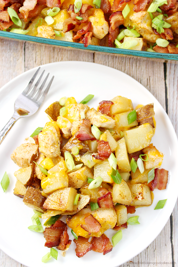 Make this Loaded Potato and Chicken Casserole tonight! Seasoned potatoes and chicken are baked together and then topped with plenty of cheese, green onions and bacon! #BaconMonth2015