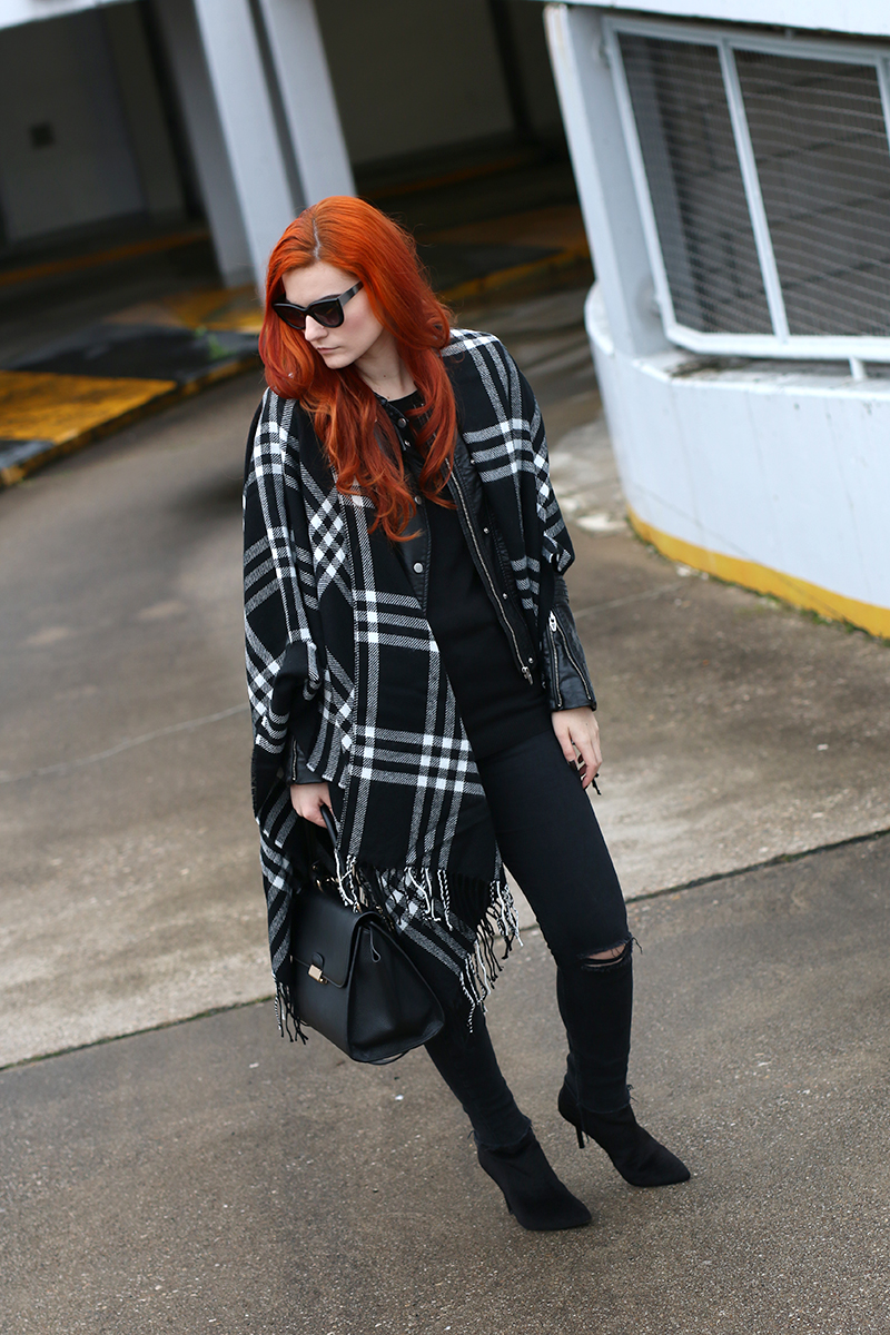 Black leather jacket and checked poncho with trapeze bag