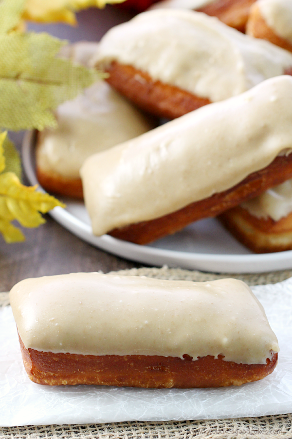 Maple Bars on a plate with one on a napkin.