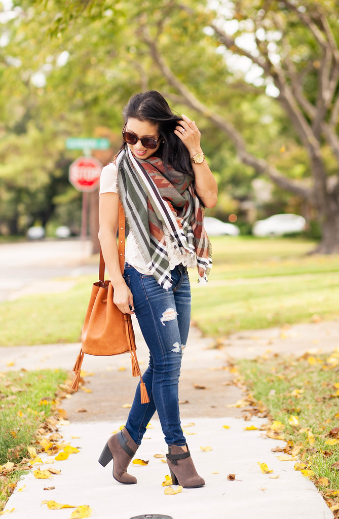 cute & little blog | petite fashion | fall blanket scarf, distressed jeans, tassel bucket bag, ankle boots | fall outfit
