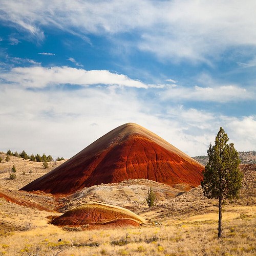 Photograph by @susanseubert // Painted Hills is one of the three parts of the John Day Fossil Beds National Monument in Oregon. This area is named after the colorful layers of its hills, formed from bands of laterite, corresponding to various geological e