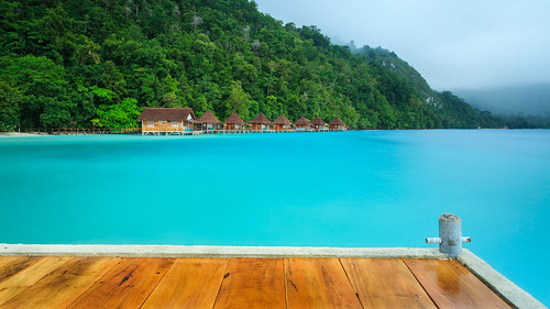 oraecoresort pulau seram moluccas island hut pier wooden turquoise blue green fog indonesia