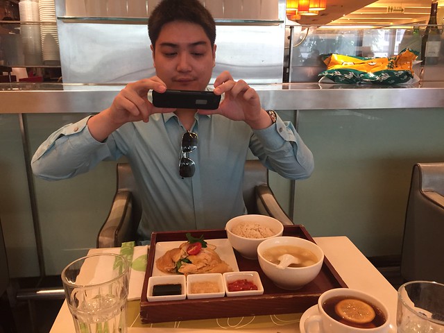 My son taking pictures of the Hainan chicken