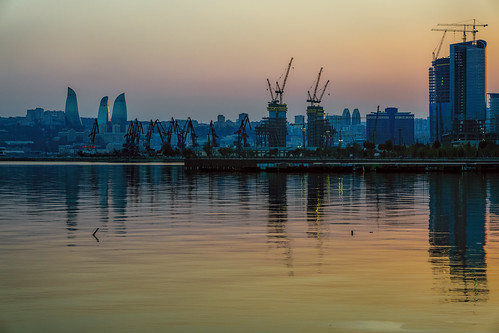 city blue light sunset orange green silhouette yellow port buildings reflections emblem relax mirror golden evening construction aqua quiet peace darkness skyscrapers symbol harbour towers peach peaceful calm cranes flame silence ripples