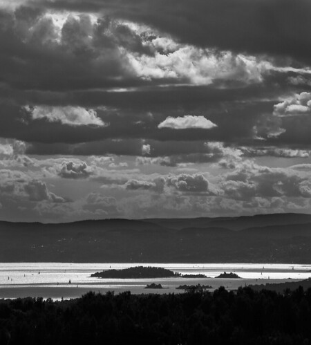 sky water oslo norway backlight clouds fjord islet shimmering islets