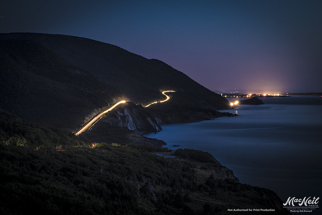 a car cruising on the oceanside Cabot Trail - late evening