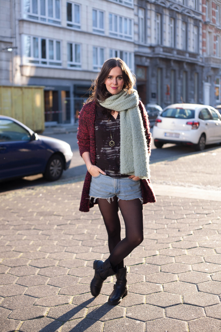 Outfit: longline cardigan, denim cutoffs, motor boots and oversized scarf
