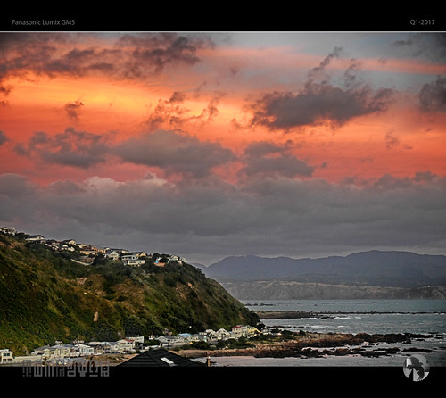 sky clouds sun sea coast hills mountains water surf houses pink tomraven aravenimage q12017 lumix gm5 his