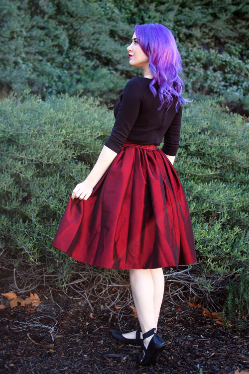 Pinup Girl Clothing Pinup Couture Jenny Skirt in Red Sharksin Taffeta Laura Byrnes Sabrina Top in Black Deer Arrow Brooch