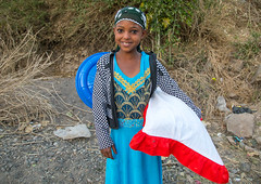 Girl carrying gifts during an Oromo wedding celebration, Amhara region, Artuma, Ethiopia