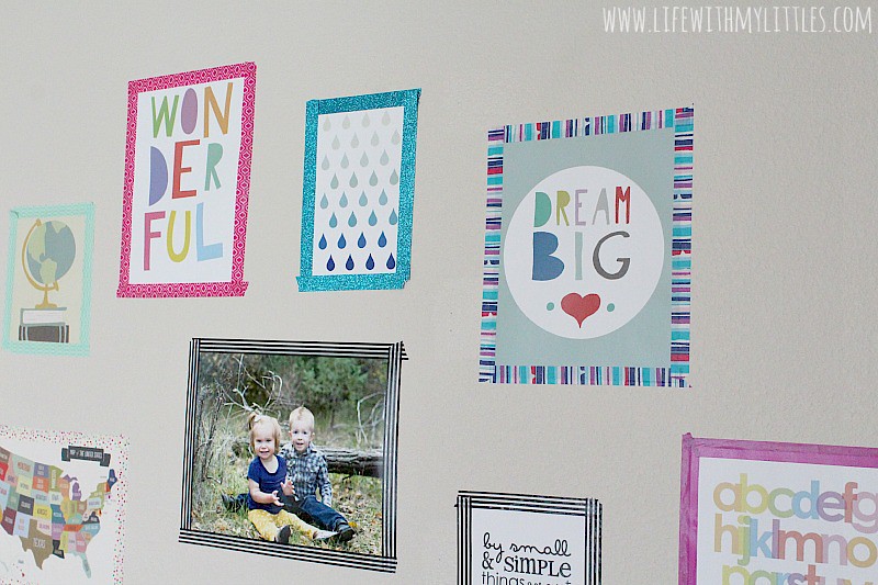 Love this renter-friendly gallery wall! What a cute way to hang up pictures without making holes in the walls! And it's so bright and colorful!