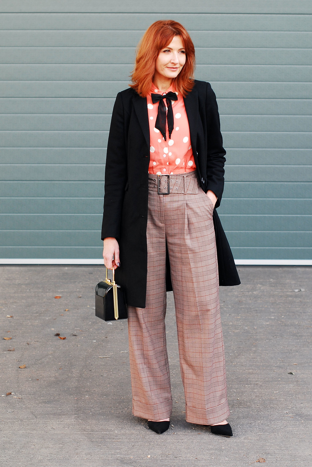 How to get the Katharine Hepburn look: Wide leg check turn up trousers \ masculine-cut black coat \ polka dot blouse with embellished black bow neck tie \ black box handbag \ cone-heeled black pointed shoes | Not Dressed As Lamb, over 40 style
