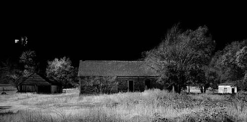 sky windmill pasture trees shadows outbuildings deterioration monochrome abandoned neglected opendoors unpaintedwood fadedpaint abandonedhouse