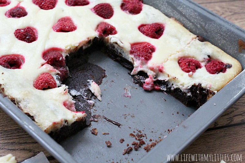 These raspberry cheesecake brownies are so easy, and so divine. Thick chocolate chunk brownies topped with homemade cheesecake and fresh raspberries! Everyone will be begging you for the recipe!