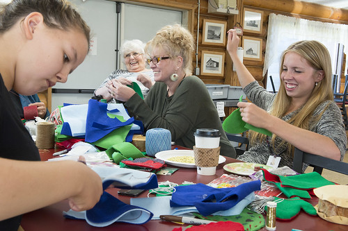 OUR VALUES: FAMILY-Nadia Walluk concentrates on her sewing  as Alexandra (Sasha) Lindgren, Lindgren's daughter Kim Sweet, and granddaughter Shayna Franke share a laugh while working on ornaments for the U.S. Capitol Christmas Tree at the Kenaitze Indian T
