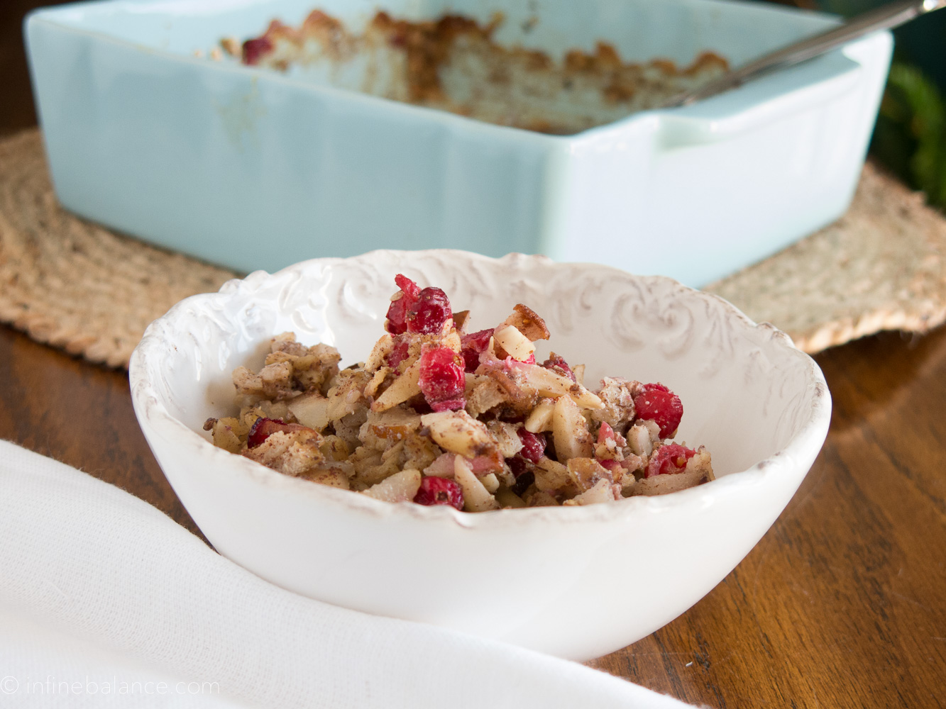 cranberry and pear baked oatmeal with almond in a white bowl