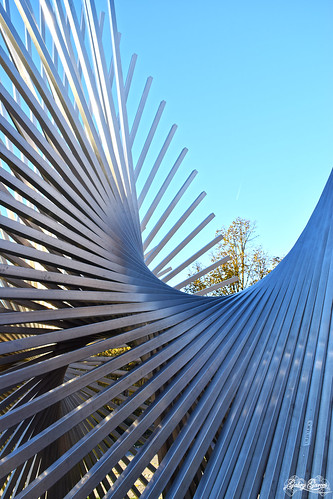 structure sculpture metal curves exhale modern shine reflections sticks iron beams parallel harmony strength background light sun sky day sunset shadows infinity crowd abstract fotolia photo town art city urban photography