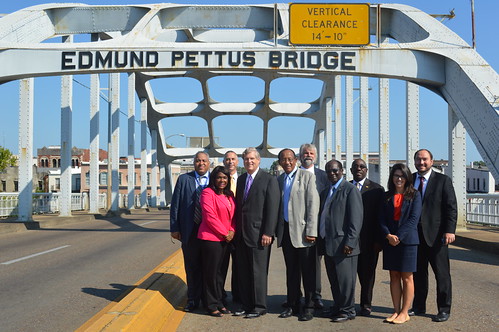 Secretary Tom Vilsack, Congresswoman Terri Sewell and Selma Mayor George Evans along with USDA State Directors and local officials at the Edmund Pettus Bridge in Selma, Ala