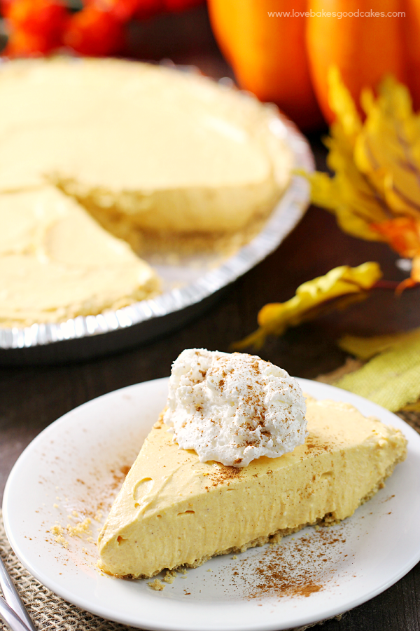 No-Bake Pumpkin Spice Cheesecake on a plate with whipped cream.