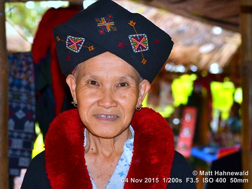 northernthailand lumien yao traveldestination tourism ethnicminority ethnic traditionalyaocostume traditionalyaoheaddress chiangrai oldwoman worldcultures redpompoms eyecontact embroidered turban nikond3100 headshot hilltribe ethnicportrait oneperson primelens nikkorafs50mmf18g photo image portrait colourful cultural character posing realpeople human humanhead mouth lips traditionalheadgear traditionalgarment consent friendly encounter emotion mood female teeth smiling sophisticated exotic happy soulful depthoffield closeup street 50mmlens fullfaceview builtinpopupflash 4x3aspectratio color eyes outdoors asia asian flash horizontalorientation matthahnewaldphotography banpaoonanglae face facingtheworld