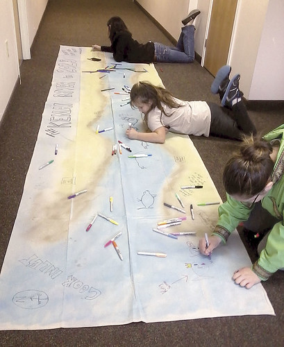 2Children work on a poster detailing the Kenai River during an Environmental Program project.