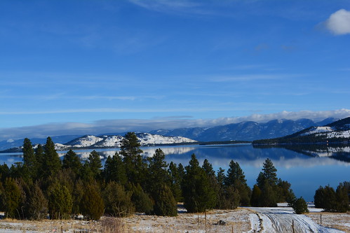 lake snow mountains reflection montana serene flathead