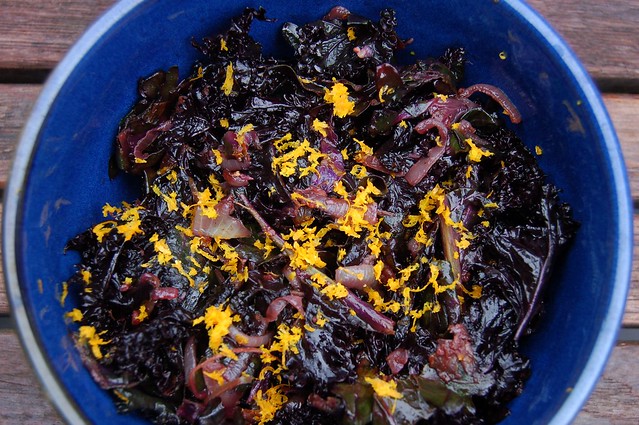 Wilted kale salad with balsamic vinegar, caramelized onions and orange zest