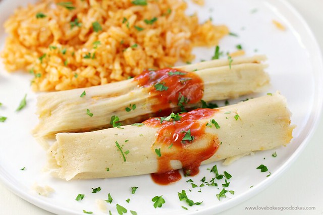 Chipotle Chicken Tamales on a plate with Mexican rice.