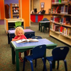Reading at the library. #longhairdontcare #iplaywithhotwheels #imaboy