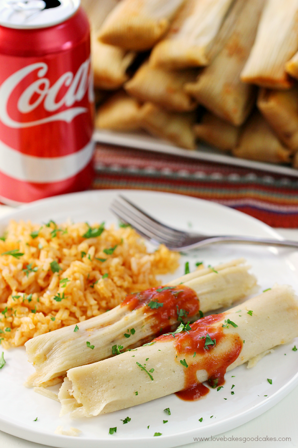 Chipotle Chicken Tamales on a plate with a can of coca cola and a fork.