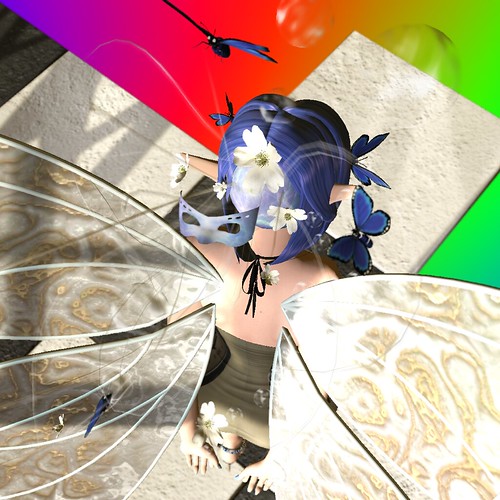 Image Description: Mid-range shock of a winged faerie from behind; her hair is backwards on her head, and a mask, bubbles, and butterflies explode from where her face would be.