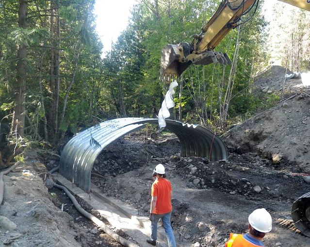 Workers replace a culvert with a larger one to accommodate higher water flows on the Colville National Forest (Photo Credit: USFS). 